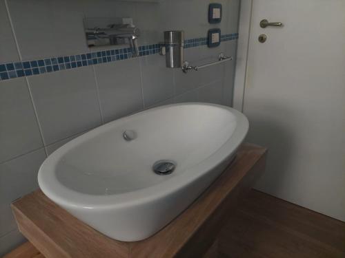 a bathroom with a white sink in a room at Blue Sea Apartment in Torre Canne