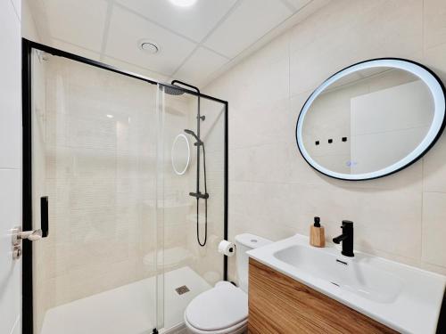 a bathroom with a shower and a sink and a mirror at Casa Natura Arena Beach in Puerto Marino