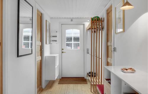 a hallway with white walls and a white door at 2 Bedroom Amazing Home In Tisvildeleje in Tisvildeleje