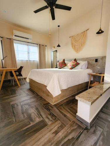 a bedroom with a large bed and a ceiling fan at Departamento con Terraza in La Paz