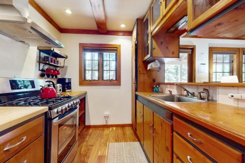 a kitchen with wooden cabinets and a stove top oven at Carnelian Bay Paradise in Carnelian Bay