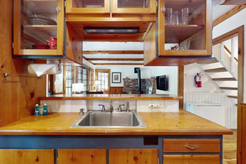 a kitchen with a sink and wooden cabinets at Carnelian Bay Paradise in Carnelian Bay