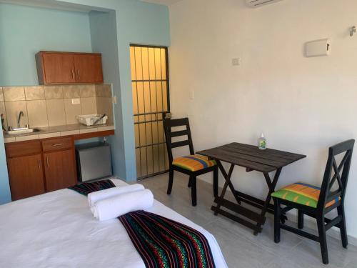a room with a bed and a table and chairs at Departamentos privados In Wotoch in Valladolid
