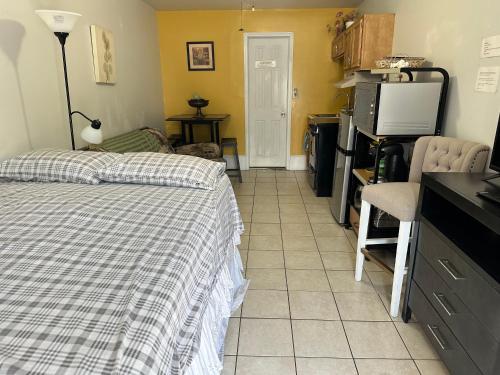 a bedroom with a bed and a kitchen with a microwave at Full bed studio near Temple and Center city Philadelphia in Philadelphia