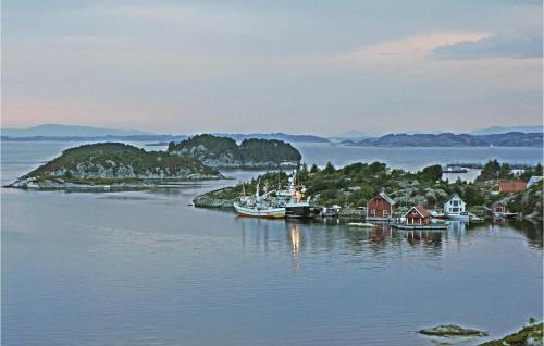 a small island in the water with boats in it at Gorgeous Home In Bekkjarvik With Wifi in Bekkjarvik