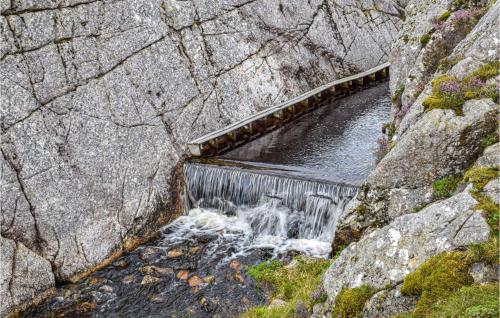 a dam on a river with water rushing through it at Gorgeous Home In Bekkjarvik With Wifi in Bekkjarvik