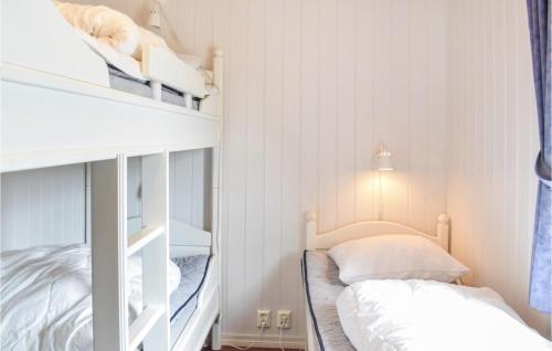 a small bedroom with two bunk beds and a bed at Gorgeous Home In Bekkjarvik With Wifi in Bekkjarvik