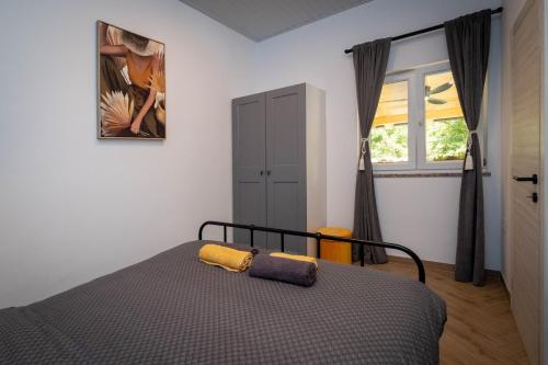 a bedroom with a bed and a window at Relaxing Holiday Apartment in Kornić