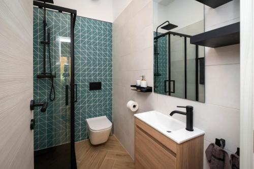 a bathroom with a toilet and a sink and a shower at Relaxing Holiday Apartment in Kornić