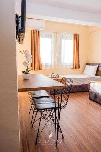 a room with a table and chairs and a bed at Villa Irina in Ohrid