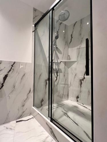 a shower in a bathroom with white marble at Modern Stay I Cosy & Central Apartments in Koblenz