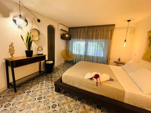 a bedroom with a bed with a hat on it at Duba Holiday House in Palermo