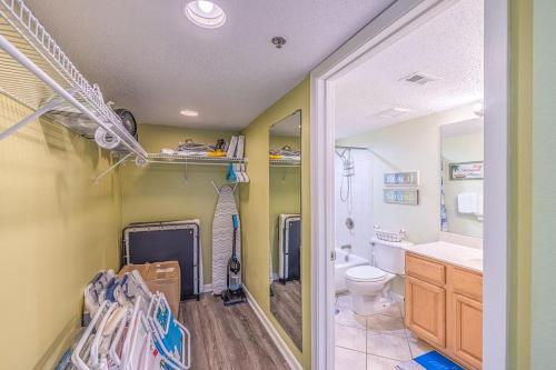 a bathroom with a toilet and a sink at Family Tides-The Ultimate Family Beachfront Condo! in Fort Walton Beach