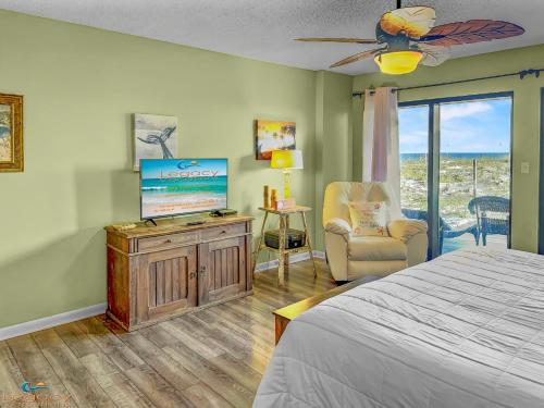 a bedroom with a bed and a flat screen tv at Family Tides-The Ultimate Family Beachfront Condo! in Fort Walton Beach