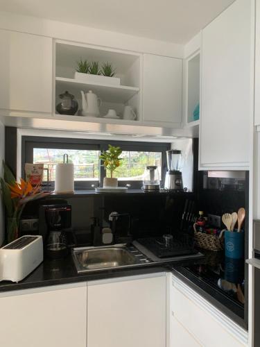 a kitchen with a sink and a counter top at Quinta da Oliveira in Ponta do Sol