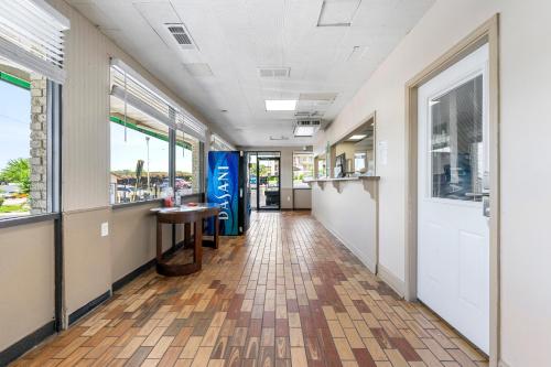 an empty hallway in a building with a table and windows at Budgetel Inn and Suites in Atlanta