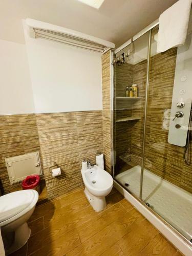 a bathroom with a toilet and a shower and a sink at Duba Holiday House in Palermo