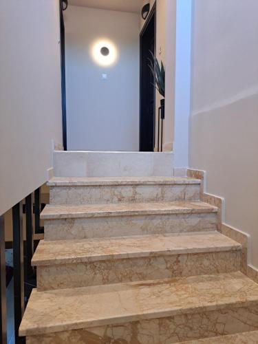a set of stairs leading to a hallway with a door at Zafirakis Suites Amaliada in Amaliás