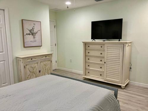 a bedroom with a flat screen tv on a dresser at Brand New, Peaceful, and Dogs Stay Free in Marion Oaks
