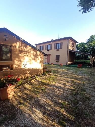 a house with a yard next to a building at La Cascina della Vachina in Poggio Bustone