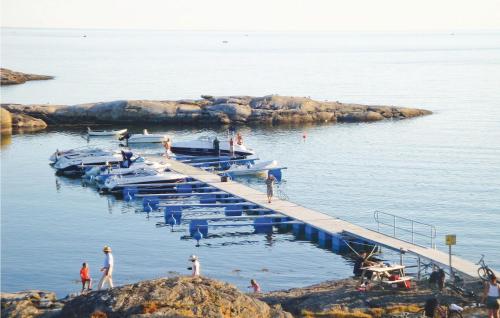 people standing on a dock with boats in the water at Villa Adenäs in Åsa