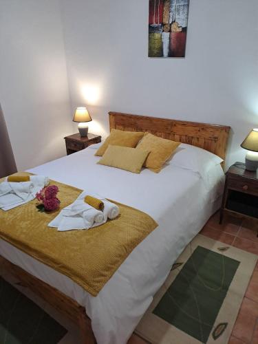 a bedroom with a bed with towels on it at A Casa dos Avós in Lajes das Flores