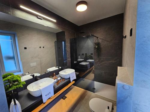 a large bathroom with two sinks and a shower at MA PE Luxury Rooms in Split