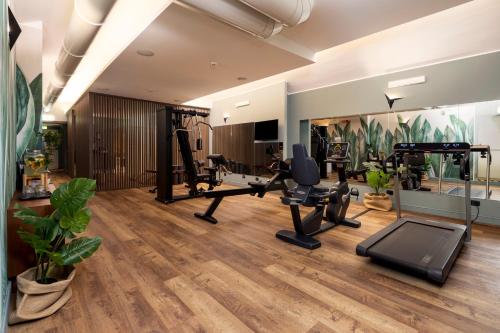 a gym with treadmills ellipticals and a treadmill at Hotel Indigo Turin by IHG in Turin
