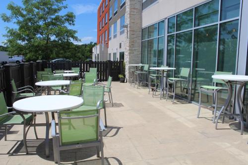 a row of tables and chairs in front of a building at Holiday Inn Express & Suites - Gettysburg by IHG in Gettysburg