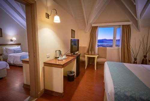 Ένα ή περισσότερα κρεβάτια σε δωμάτιο στο Alto Calafate Hotel