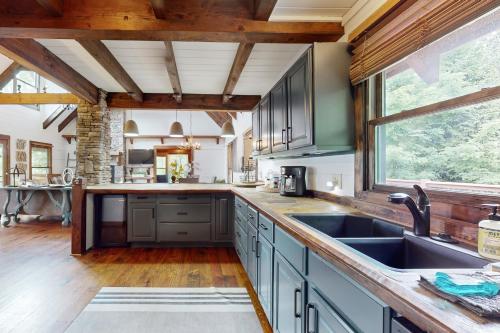 a kitchen with a sink and a large window at Crestwood Retreat in Arden
