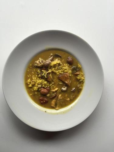 a white bowl of soup on a white table at Masía La Safranera in Alcoy