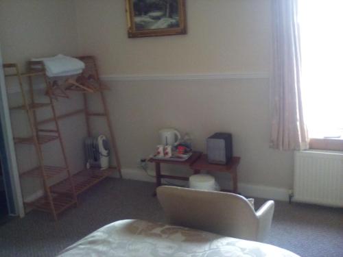 a bedroom with a bed and shelves and a window at The Merchants House in Cairnryan