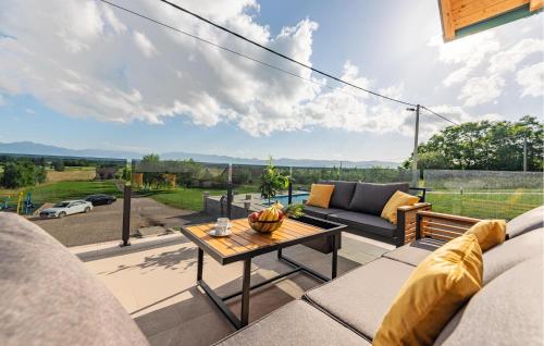a living room with a couch and a table at Beautiful Home In Musaluk in Mušaluk