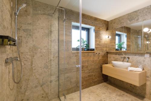 a bathroom with a shower and a sink at Aquilo Apartmanok in Tihany