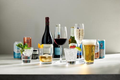 a table with wine glasses and bottles of wine at Atwell Suites Austin Airport by IHG in Austin
