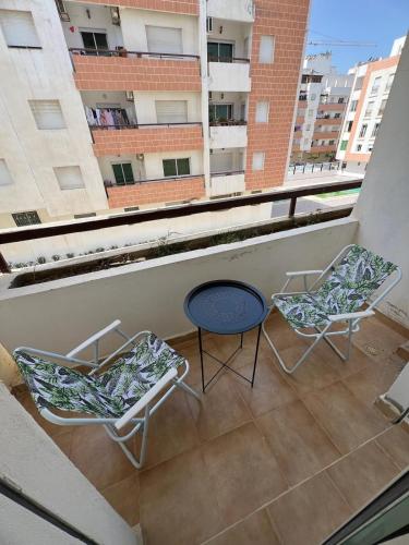 two chairs and a table on a balcony at Yousa Home & pool in Gzennaïa