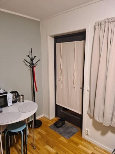 a room with a table and a table and a window at Small studio appartment in Tromsø