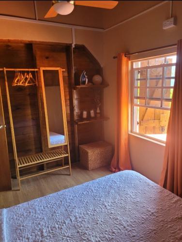 a bedroom with a bed and a window at portsmouth Cottage Haven Escapes in Portsmouth