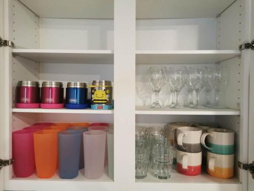 a cabinet filled with glasses and wine glasses at Fun Games and Spacious 4BR House 3 ML to Lackland AFB close to SeaWorld in San Antonio