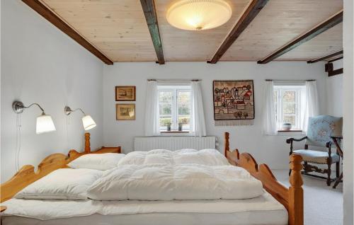 a bedroom with a large bed with white sheets at Amazing Home In Thisted With Wifi in Thisted