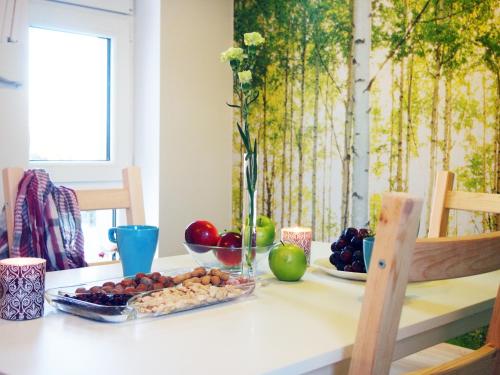 a table with a tray of fruit on it at Villa 106 in Pawłów