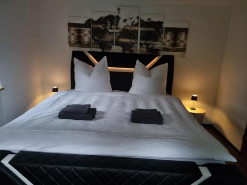 a bedroom with a large white bed with two pillows at Ferienwohnung "Seaside" in Lindenberg im Allgäu
