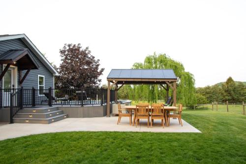 a gazebo with a table and chairs in a yard at Maple Retreat with Big Pool in Dundee