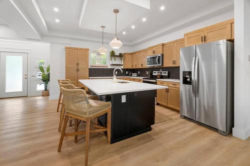 a kitchen with a stainless steel refrigerator and wooden cabinets at Maia - 109 Ridge Lane in Branson