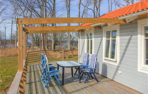 a patio with four chairs and a table on a deck at 1 Bedroom Lovely Home In Sturkö in Bredavik