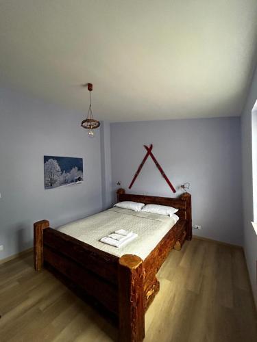 a bedroom with a wooden bed in a room at Il Fontanile in Aisone