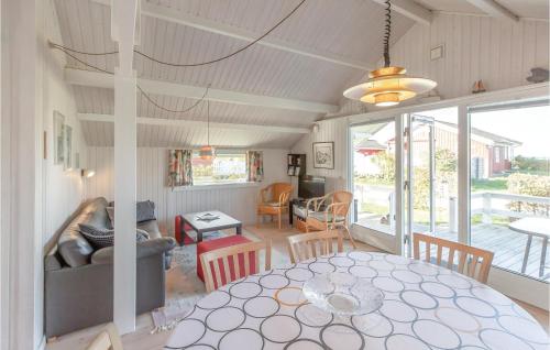 a dining room and living room with a table at Three-Bedroom Holiday Home In Brenderup Fyn in Vedelshave