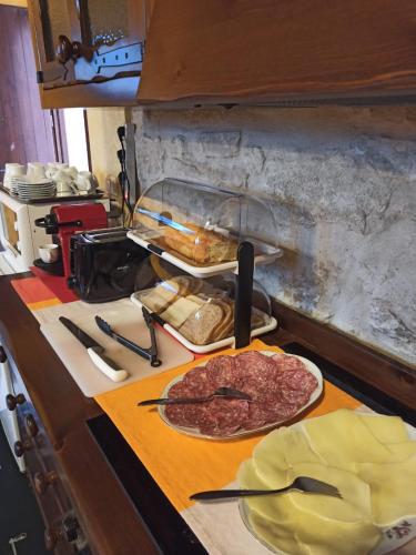 a kitchen counter with meat on a cutting board at La Cascina della Vachina in Poggio Bustone