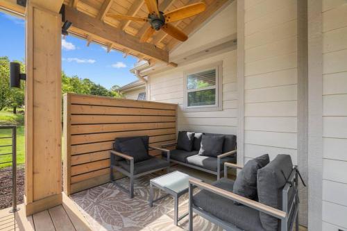 a patio with two chairs and a table at Maia - 109 Ridge Lane in Branson